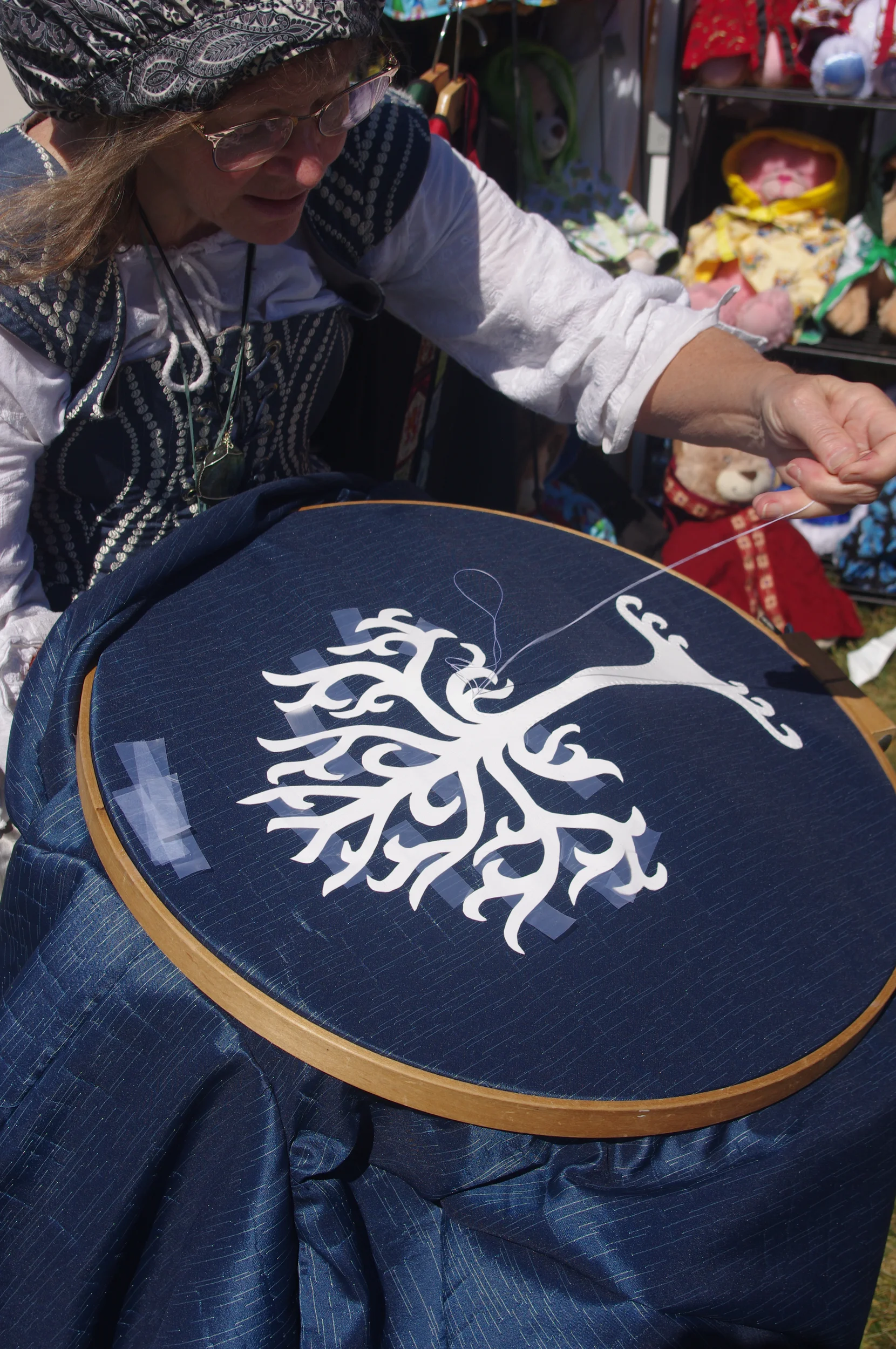 Artisan sewing a needlework pattern