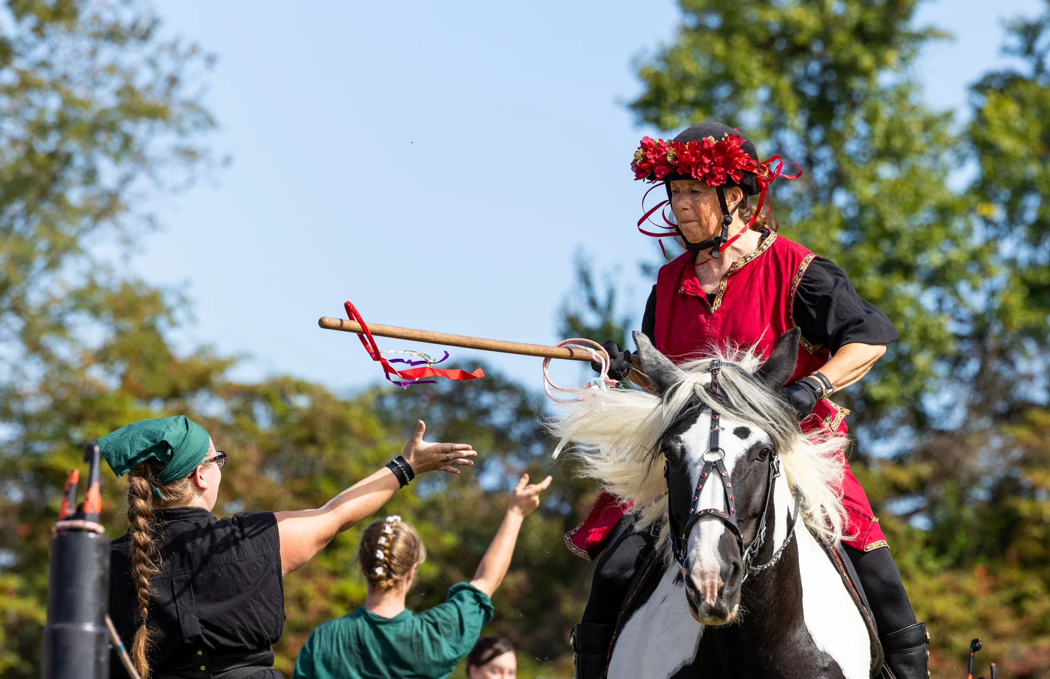 Lady knight catching a ring on her lance